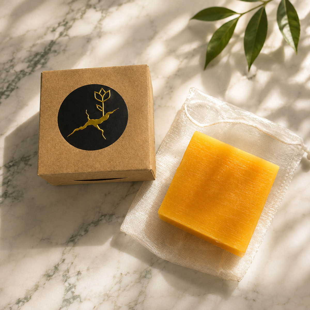 Golden Turmeric — The Radiant Dawn orange-yellow soap displayed with its kraft box and cotton pouch