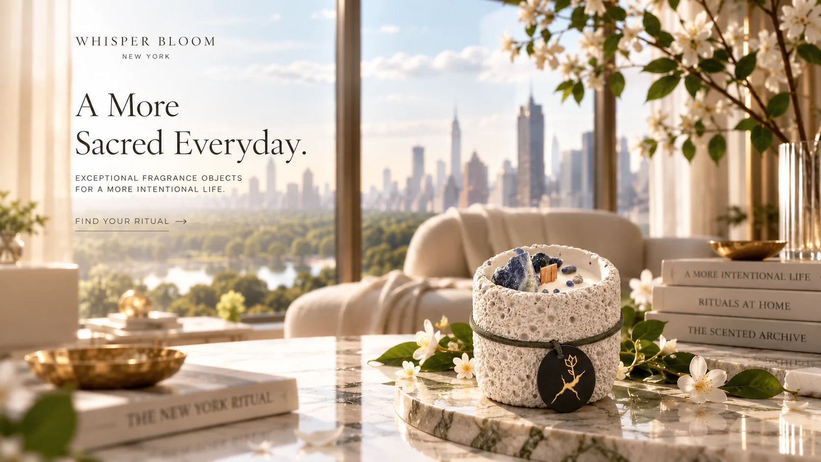 A More Sacred Everyday. A Whisper Bloom stone candle with sodalite crystals and a gold kintsugi tag on a marble table before a window over the New York skyline.